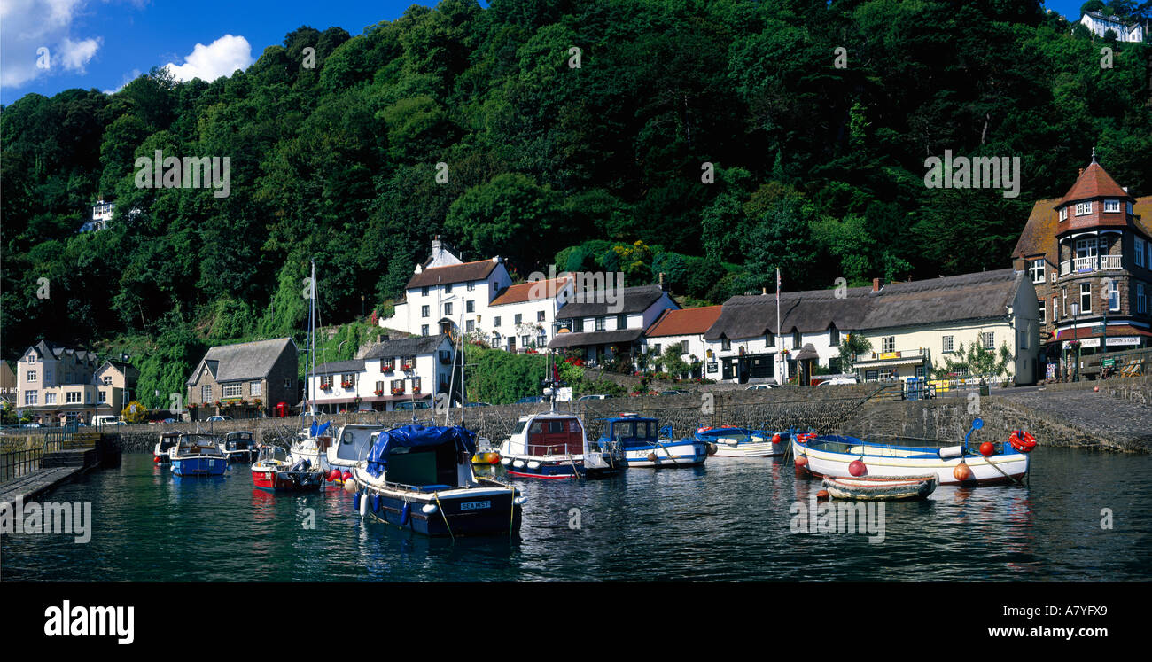 Wide angle panoramic scene of pretty Lynmouth with small colourful boats and dinghies in harbour North Devon England Stock Photo