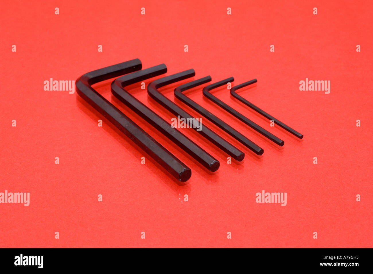 Set of small Allen keys on a red background Stock Photo