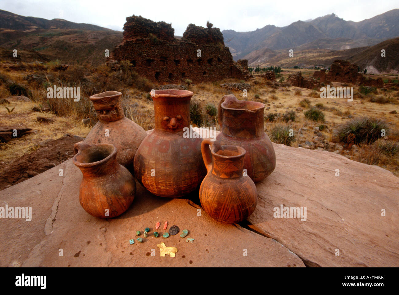 Wari Face neck jars and painted vessels, precious stones, and gold llama, cache from a single burial, Empires of the Sun, Peru Stock Photo