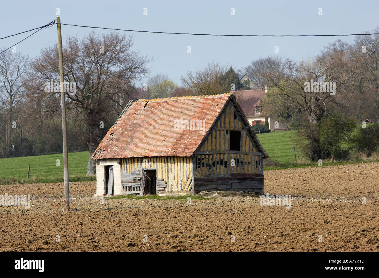 Barn in ploughed field in Pays D'Auge, Calvados, Normandy, France Stock Photo