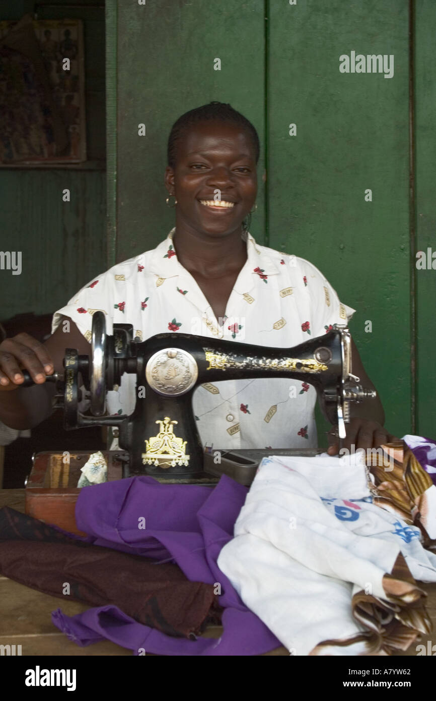 Ghanaian woman seamstress using hand operated sewing machine making and