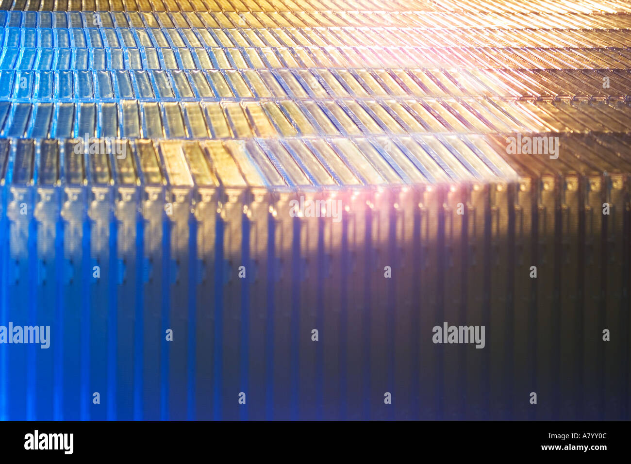 Futuristic conceptual image showing fast moving factory packaging line during production of plastic shrink wrapping around CD ROM or DVD cases in UK Stock Photo