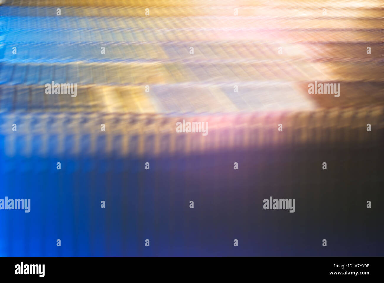 Futuristic conceptual image showing fast moving factory packaging line during production of plastic shrink wrapping around CD ROM or DVD cases in UK Stock Photo