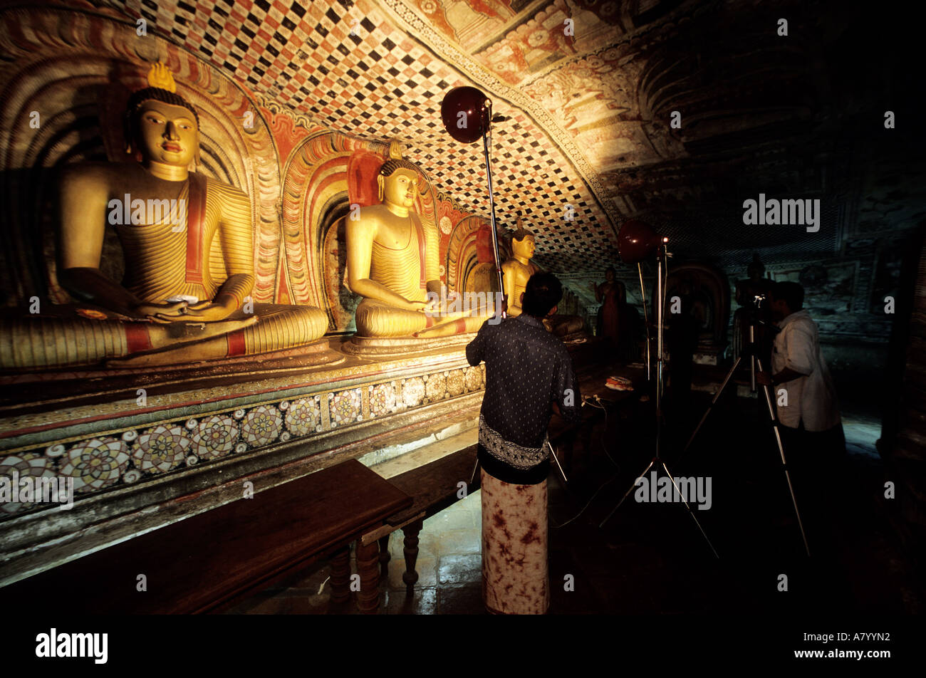Sri Lanka, North Central region, Dambulla, a ministry of cultural affairs photographer indexing the Bouddha statues of cave n°2 Stock Photo