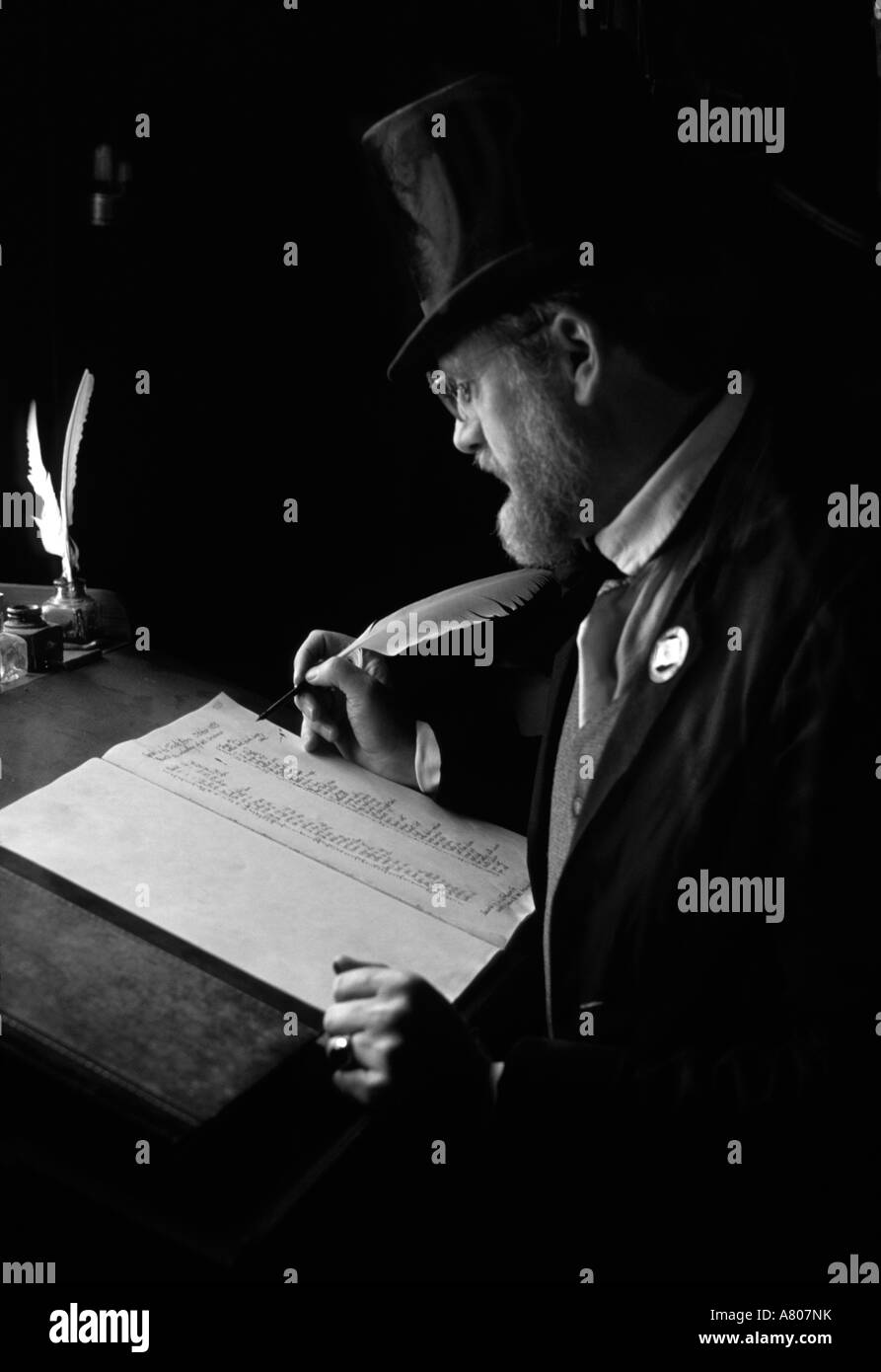 USA, Washington, Tacoma. Clerk in 1850s costume at desk with quill pen; Fort Nisqually Living History Museum (MR) Stock Photo