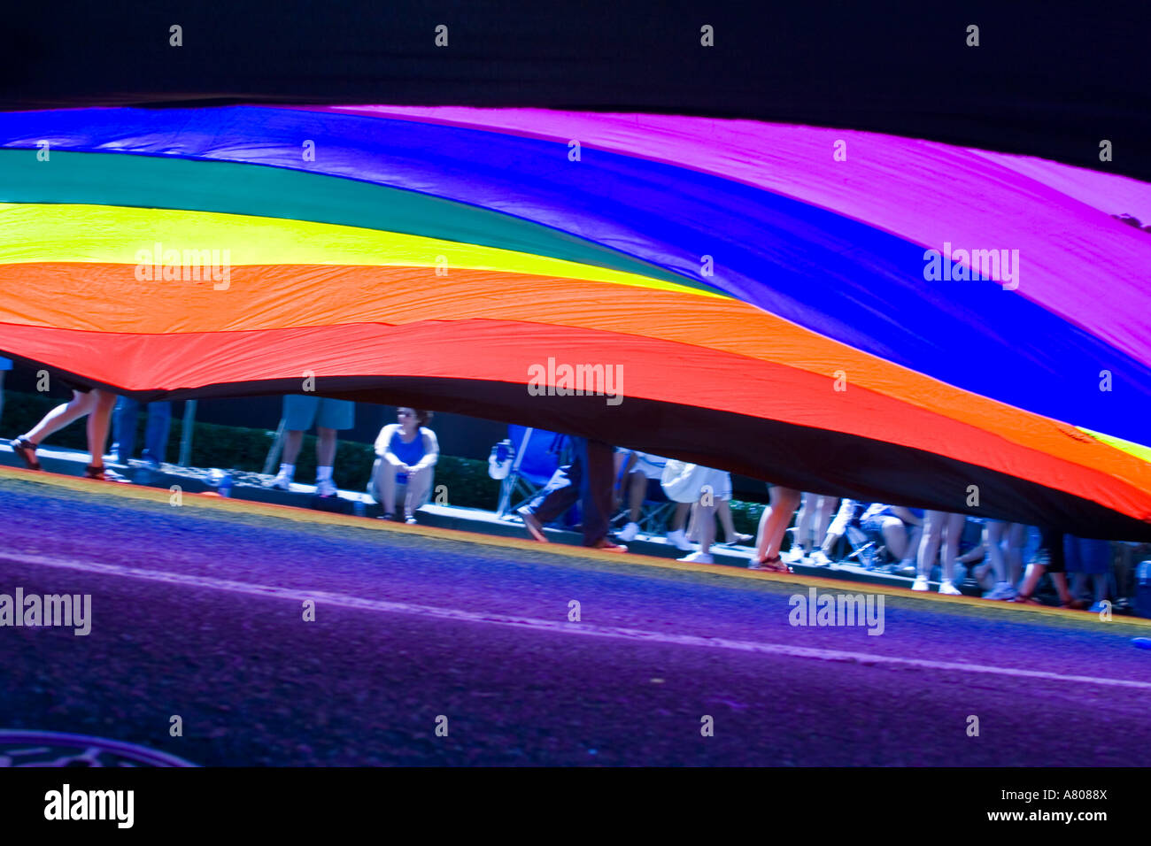 Huge rainbow flag carried by marchers in Seattle's annual Pride Parade. Stock Photo