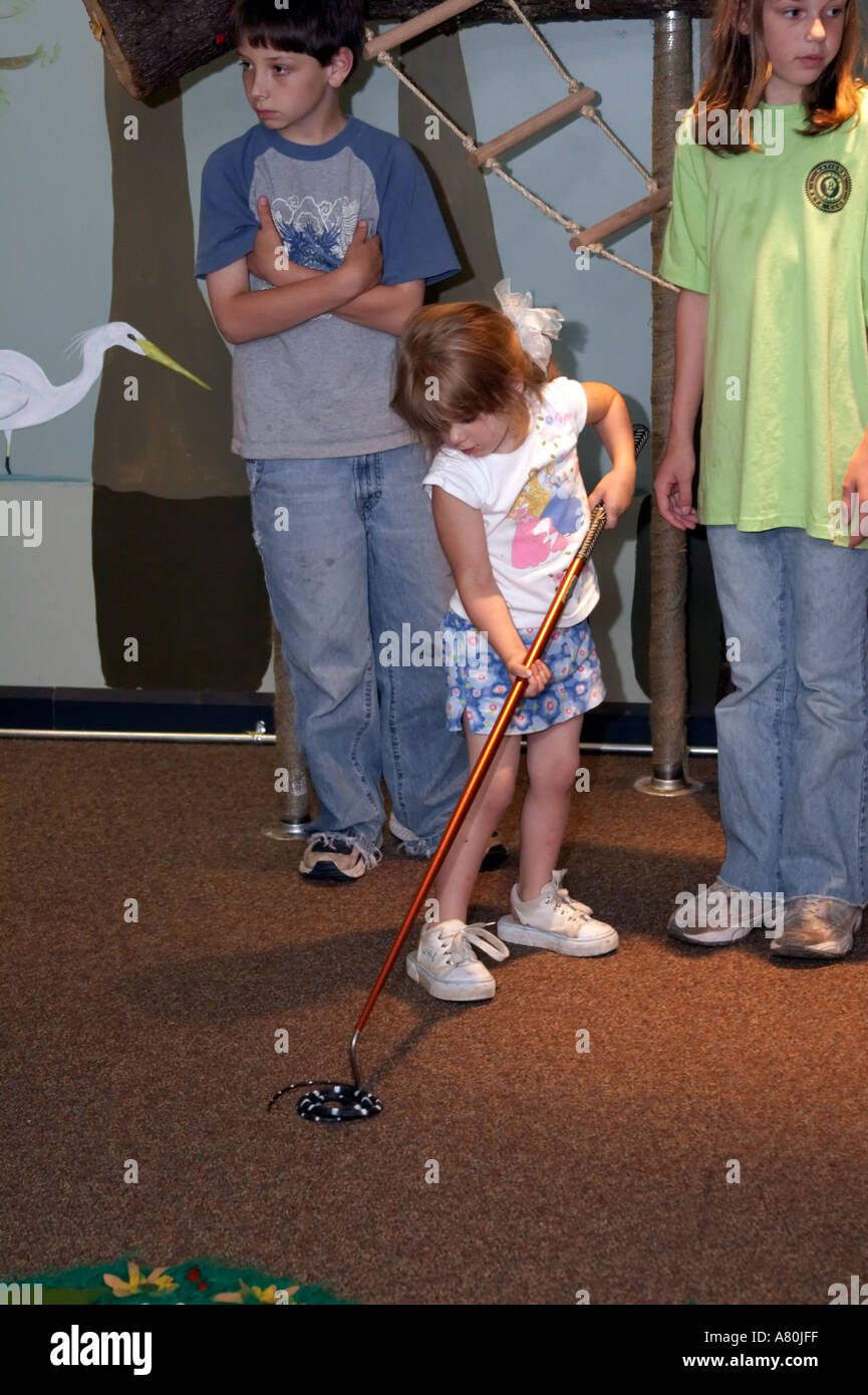 Children practicing snake handling techniques in a nature classroom ...