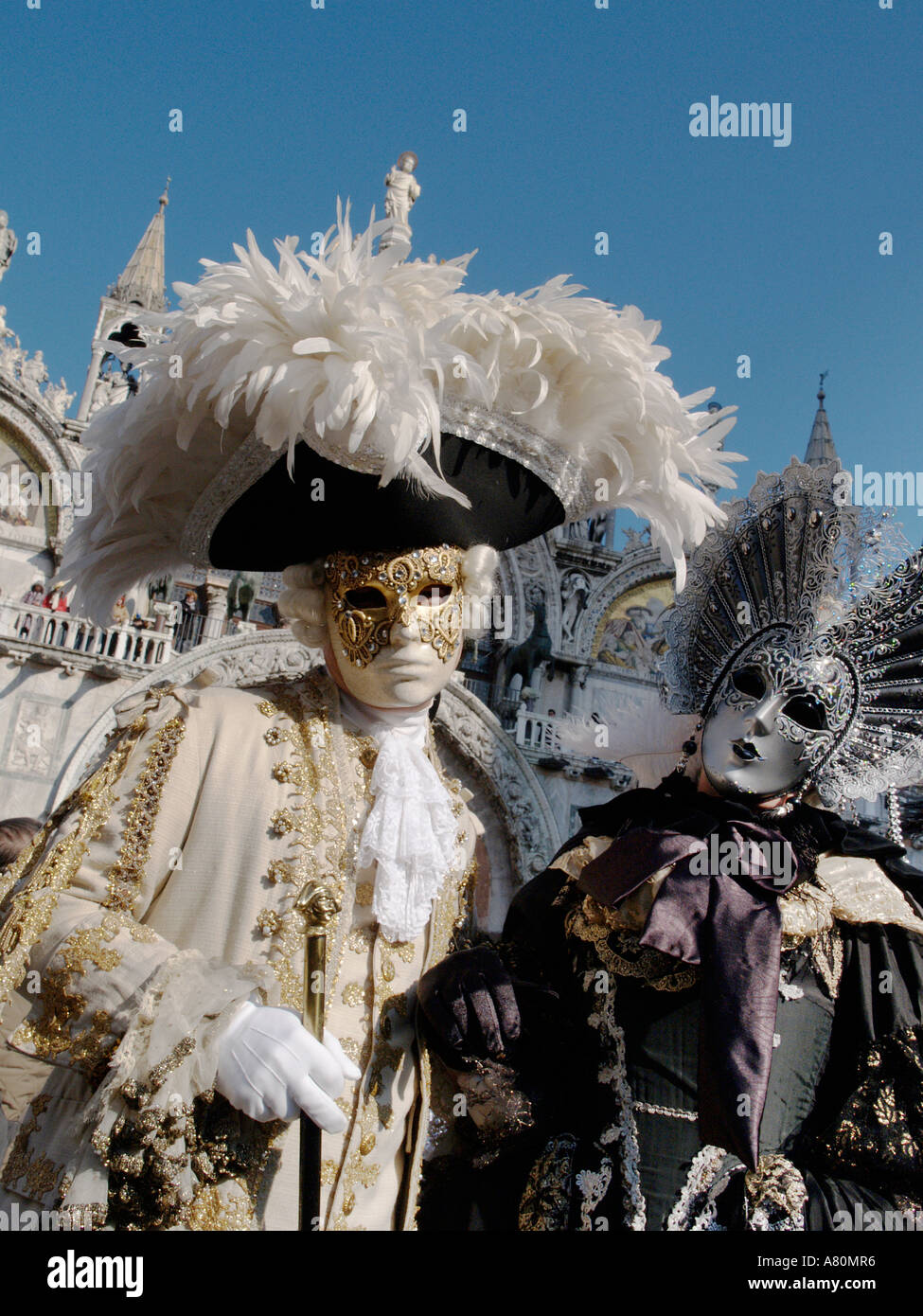 Man wearing 18th century costume and woman in silver mask Venice carnival Stock Photo