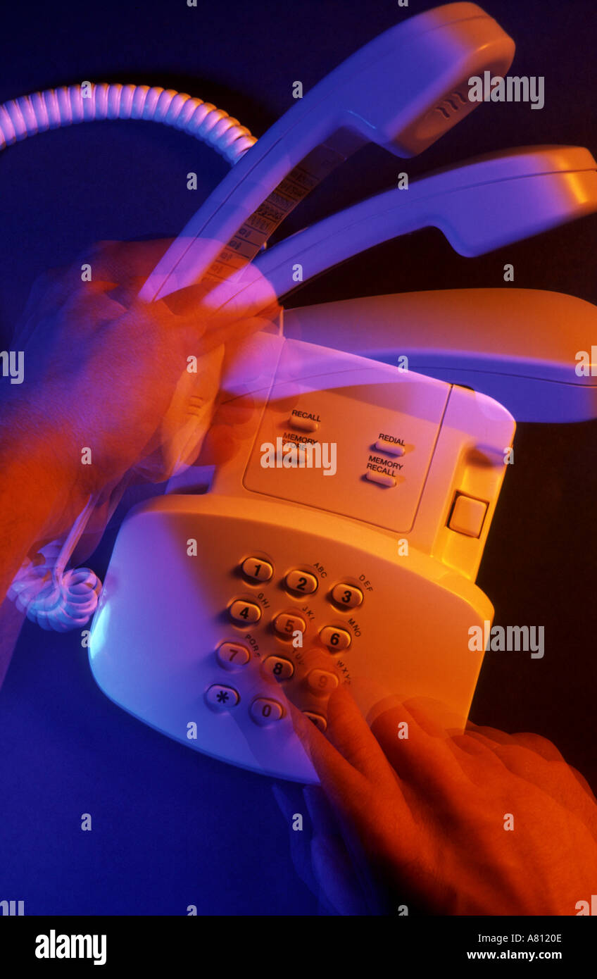 Hands picking up handset and speed dialing telephone,activity,active ...
