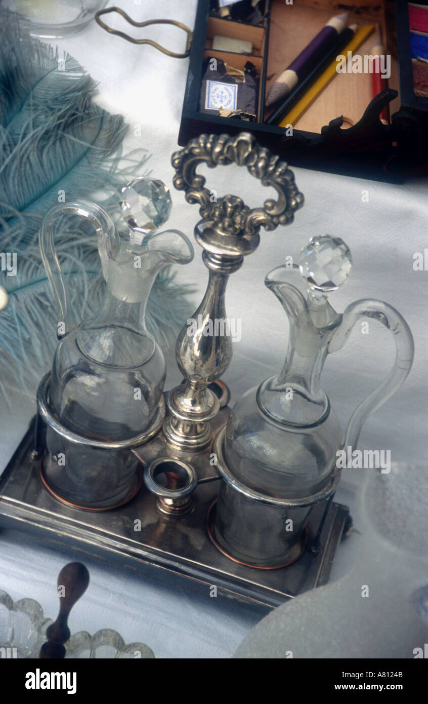 Antique decanters on silver tray for sale on French market stall Stock Photo