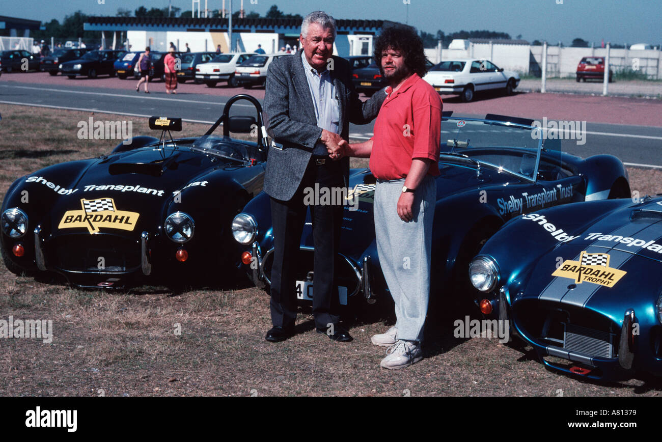 American former race driver Carroll Shelby on the left greets a fan at