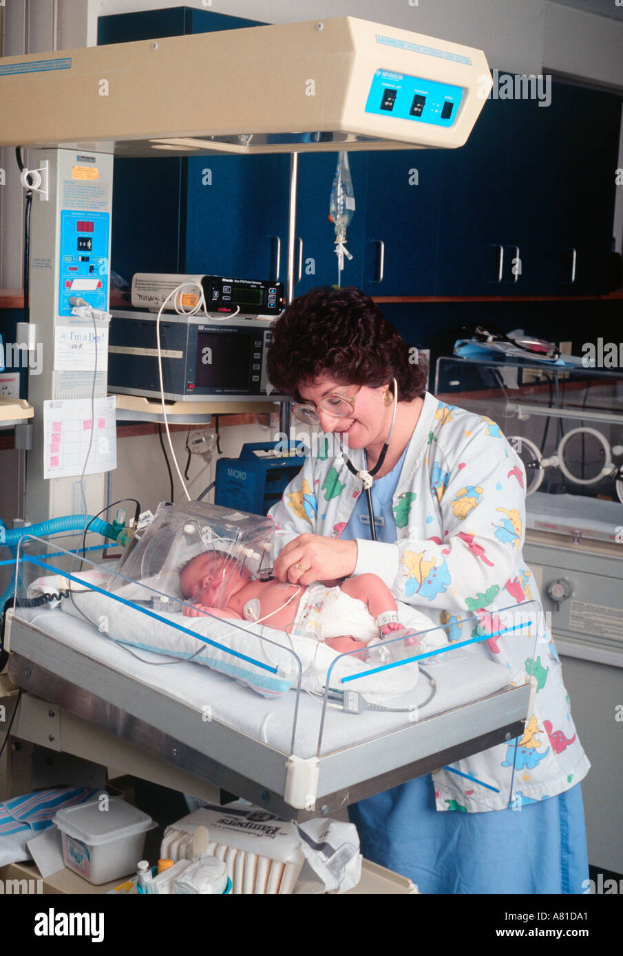 nurse listens to babies heartbeat with her stethoscope in the critical