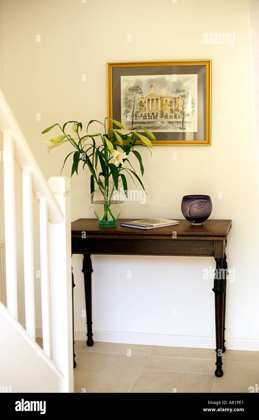 HALLWAY SHOWING TABLE WITH FLOWERS GLASS ORNAMENT AND BOOK WITH PICTURE