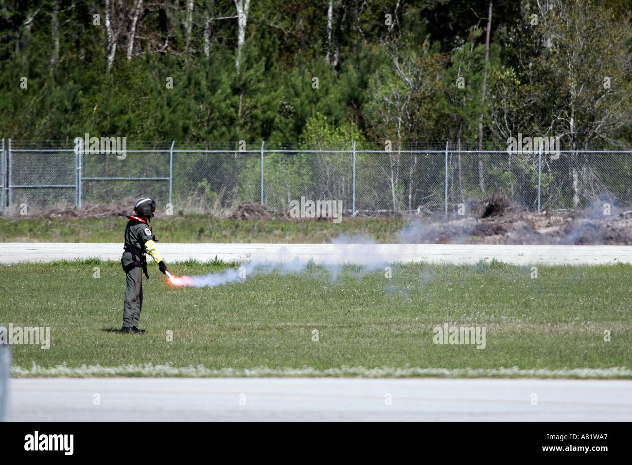 A US Coast Guard crewman lights a flare during a search and rescue demonstration at the Slidell Air Show Slidell Louisiana Stock Photo