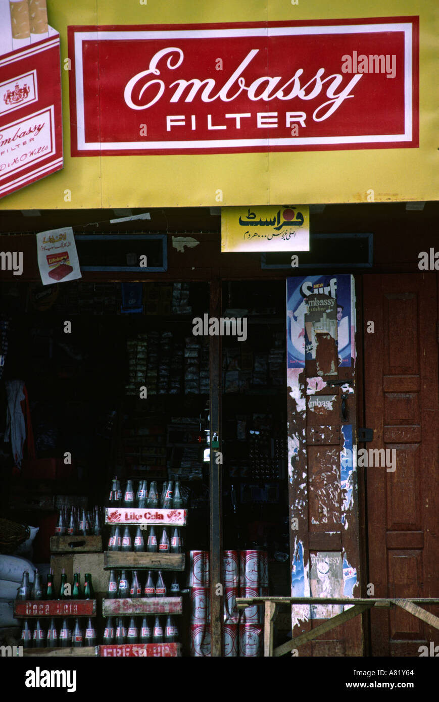 Pakistan Azad Kashmir Gilgit embassy cigarette advertising sign above drinks stall Stock Photo