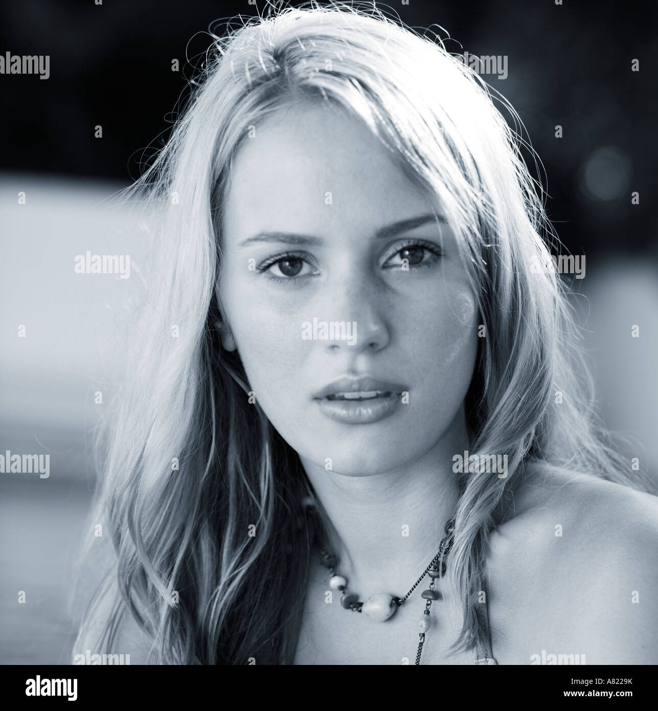 A young woman by a swimming pool Stock Photo - Alamy
