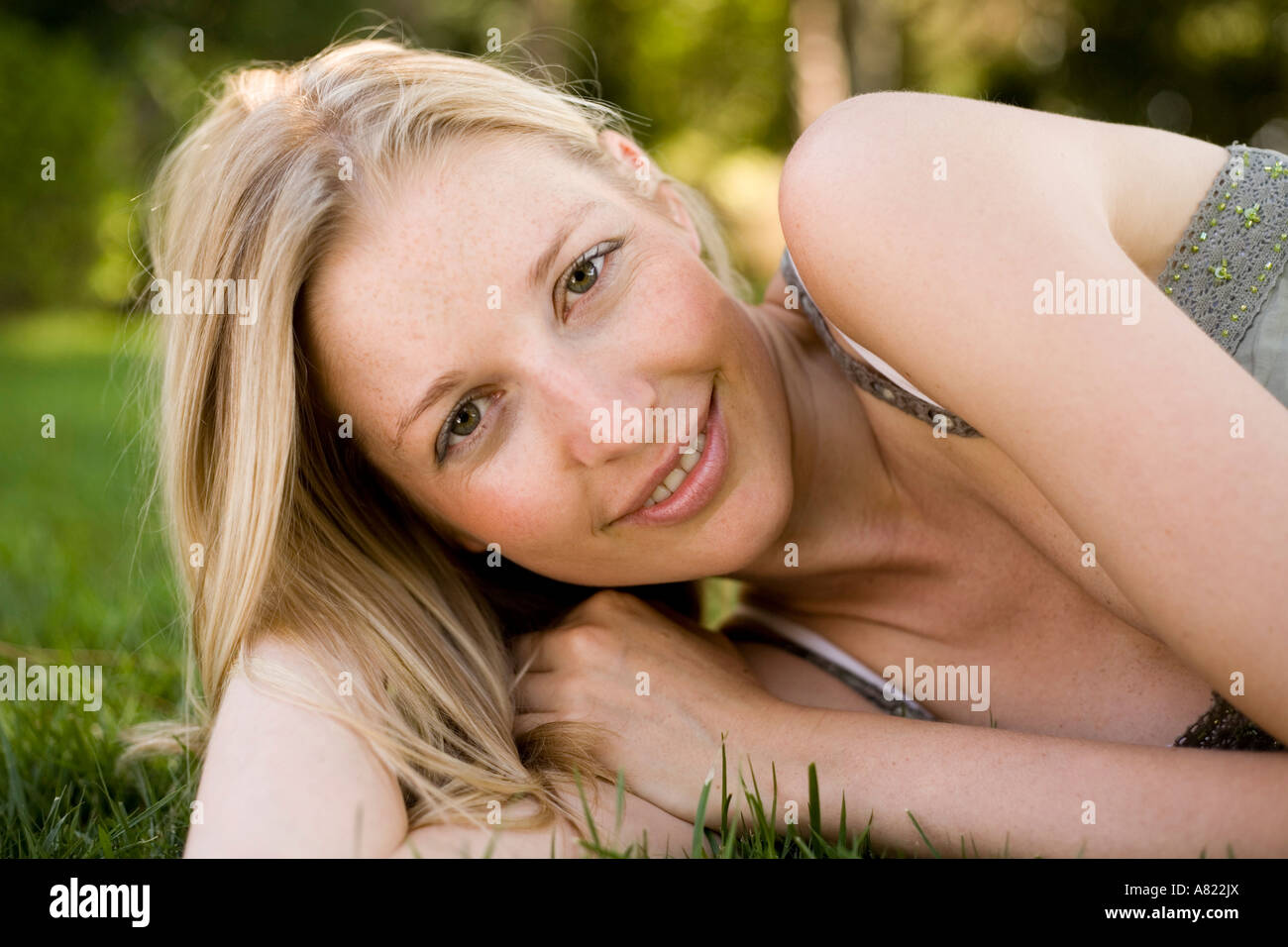 A young woman lying on the grass Stock Photo - Alamy
