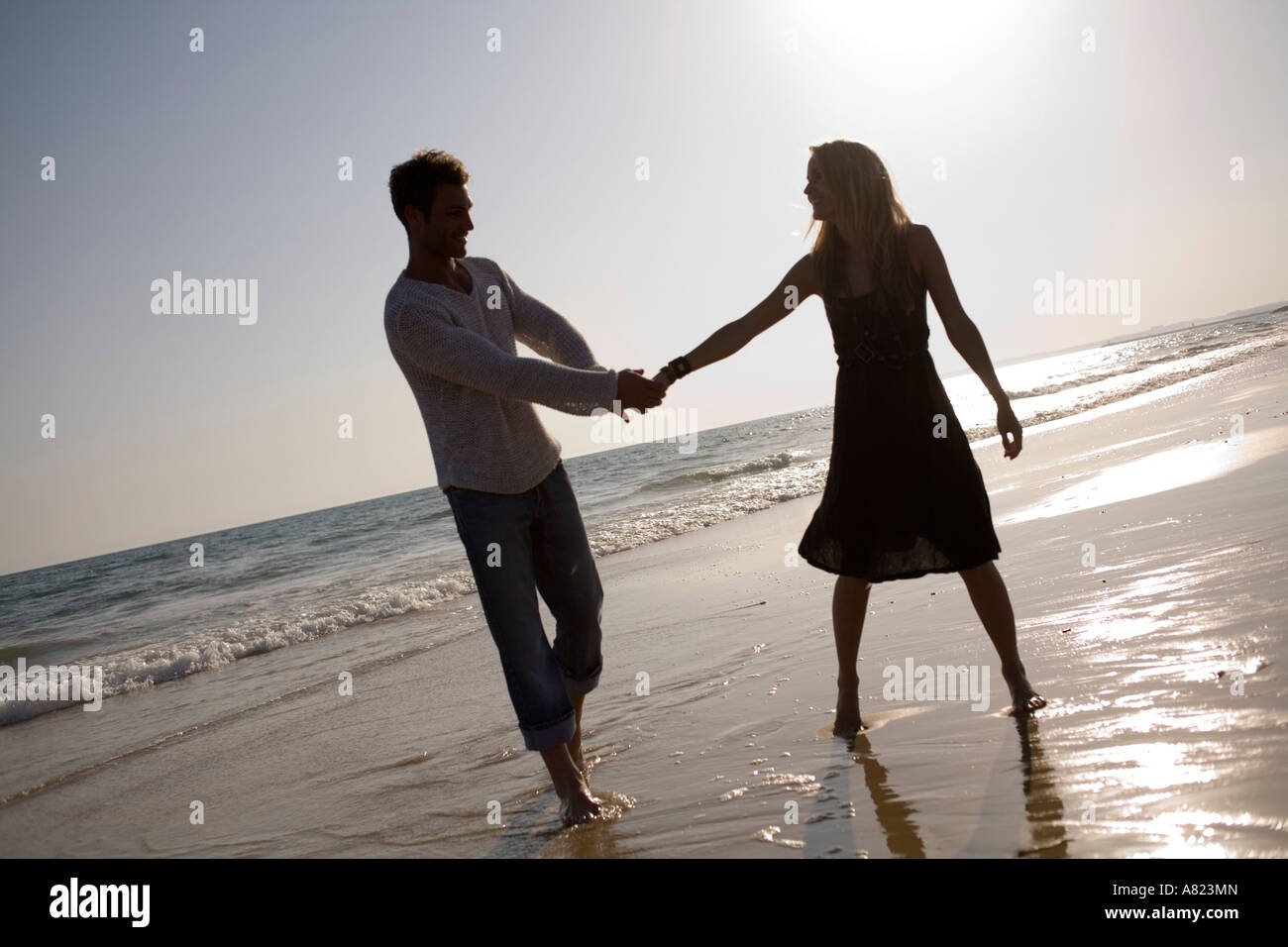 A couple at the beach holding hands Stock Photo - Alamy