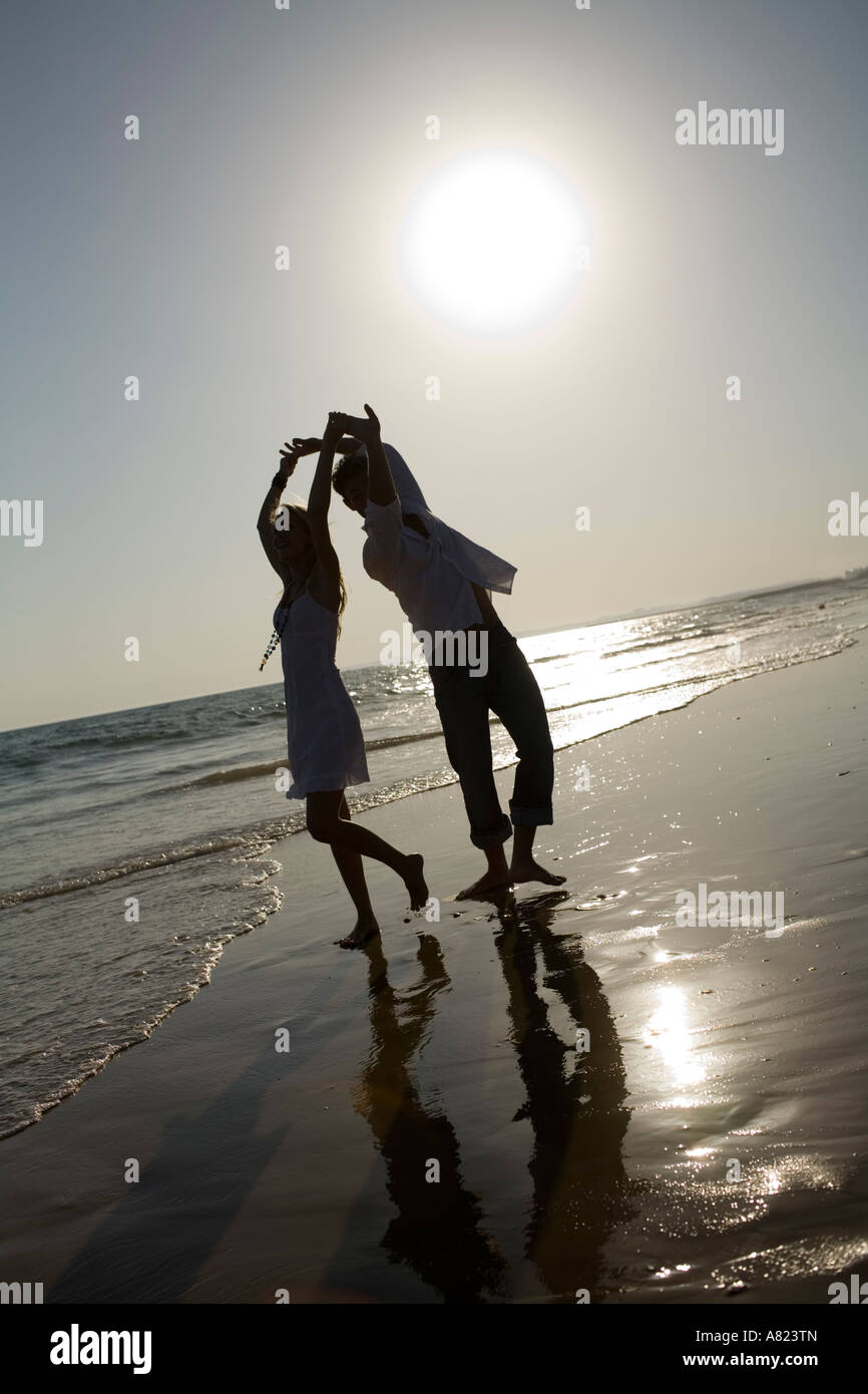 A couple at the beach holding hands Stock Photo - Alamy
