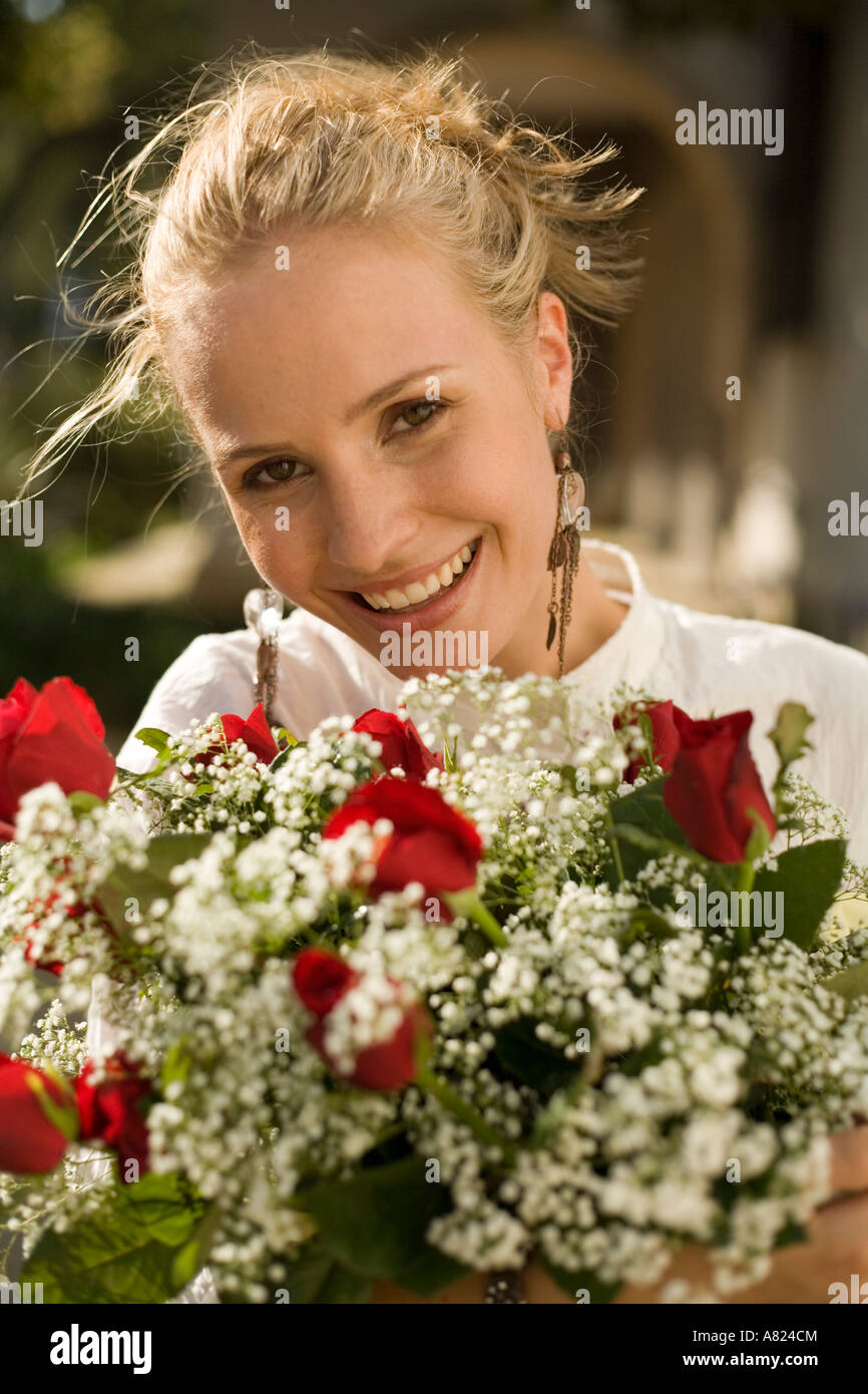 A young woman with a flower arrangement Stock Photo - Alamy