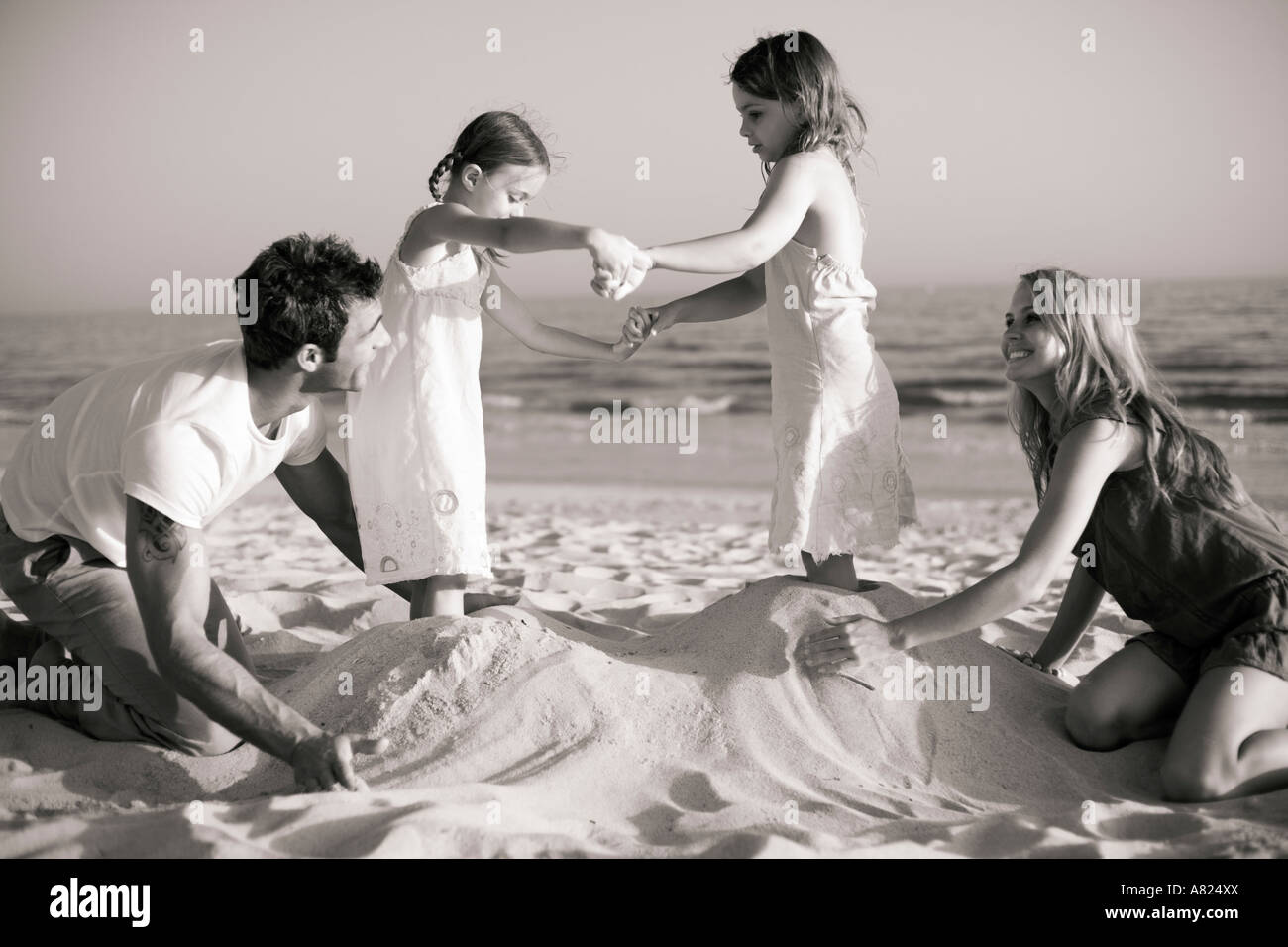 A family playing at the beach Stock Photo - Alamy