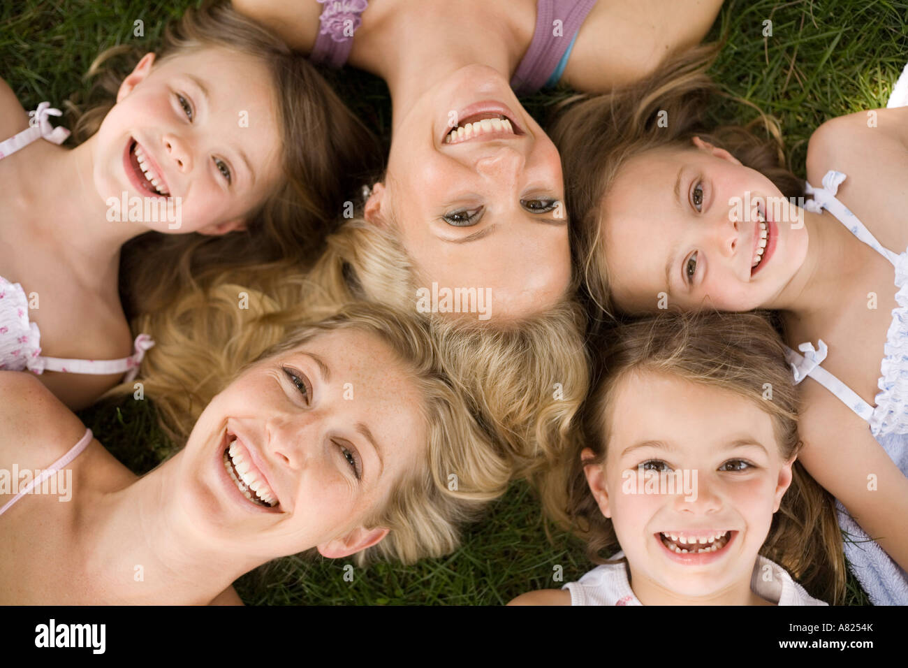 Two Mothers And Their Daughters Lying On The Grass Stock Photo Alamy Two mothers and their daughters lying on the grass stock photo alamy