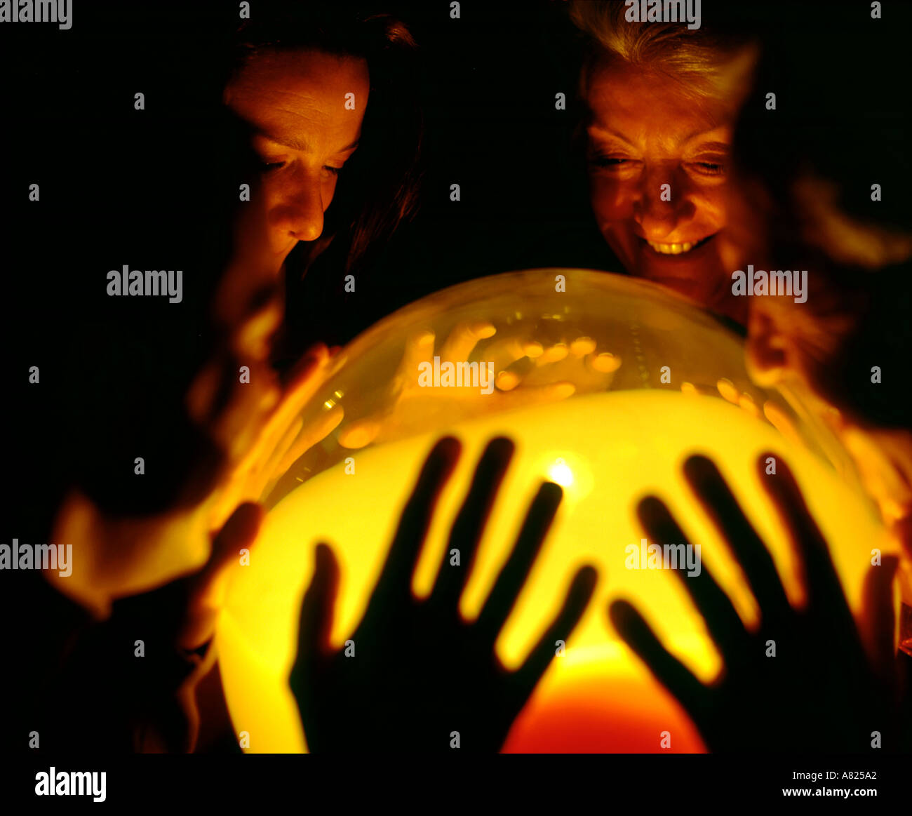 family looking into crystal ball light Stock Photo Alamy