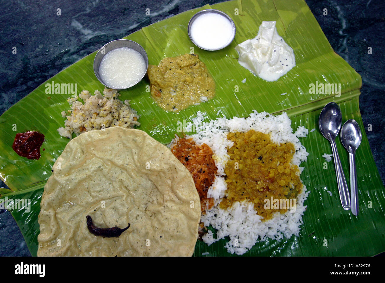 A thali a typical indian meal served on a banana leaf Stock Photo