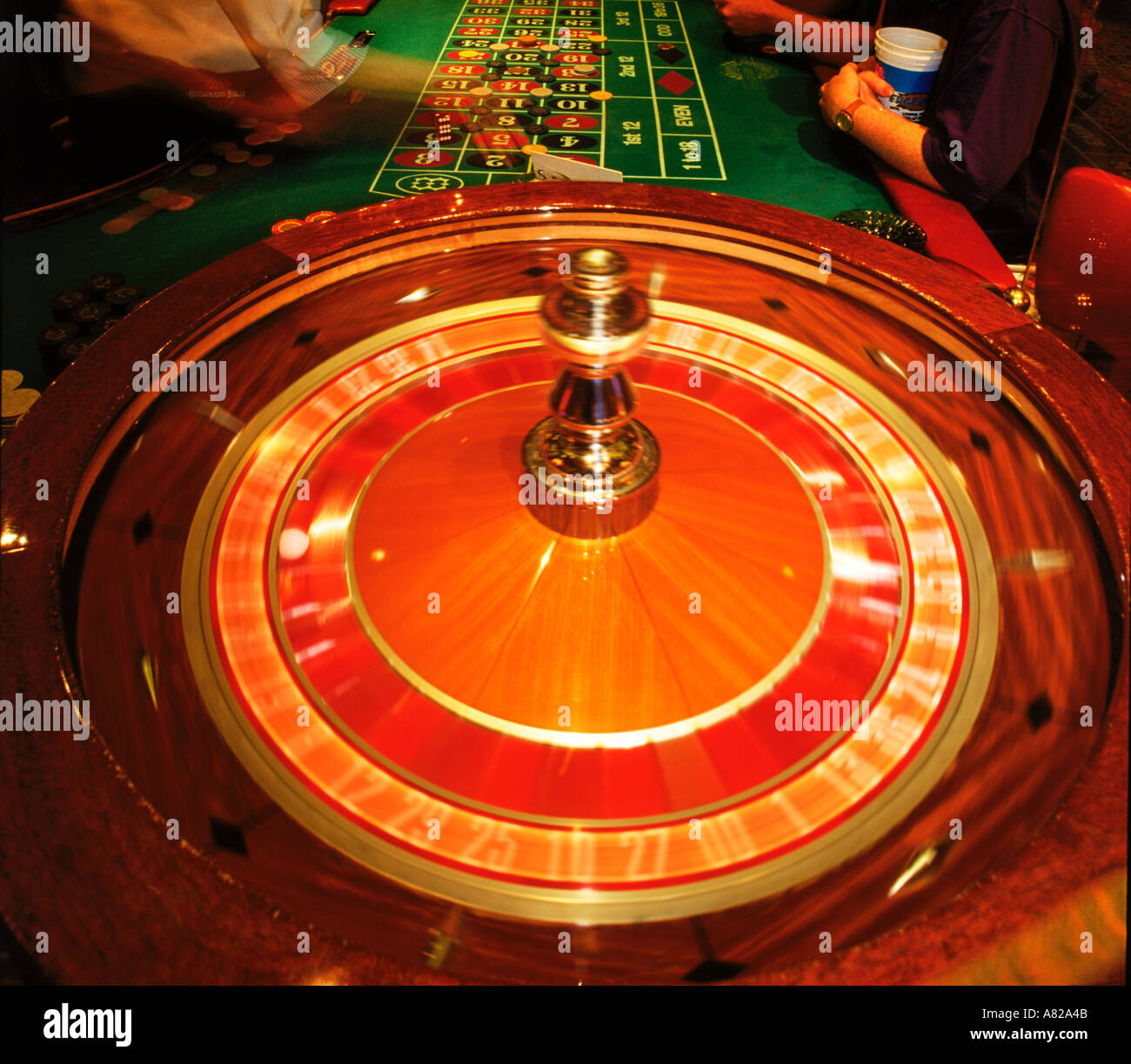 Gambling at the roulette table with chips and spinning wheel Stock