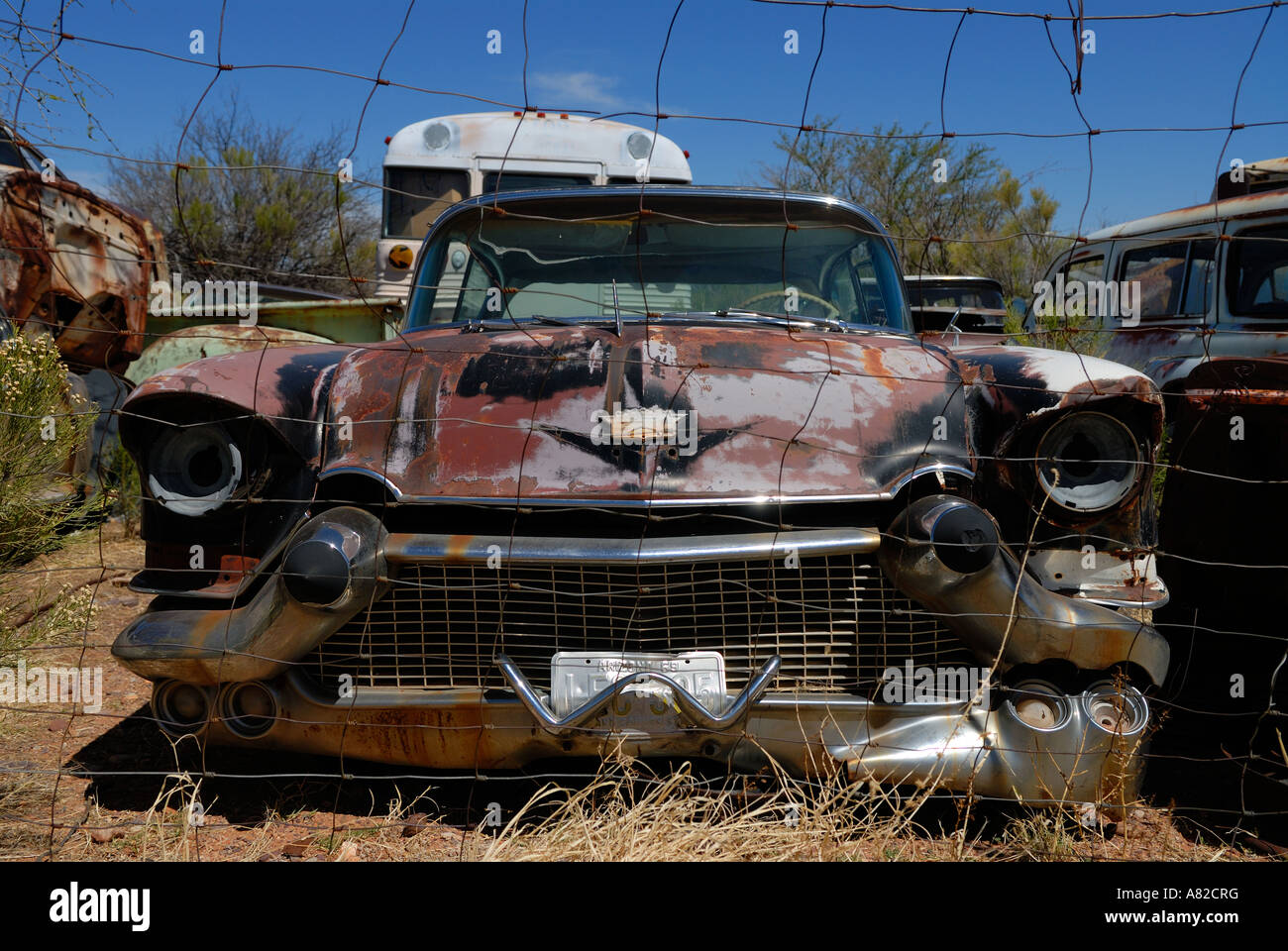 1950 s Cadillac sits abandoned in desert junkyard Stock Photo Alamy