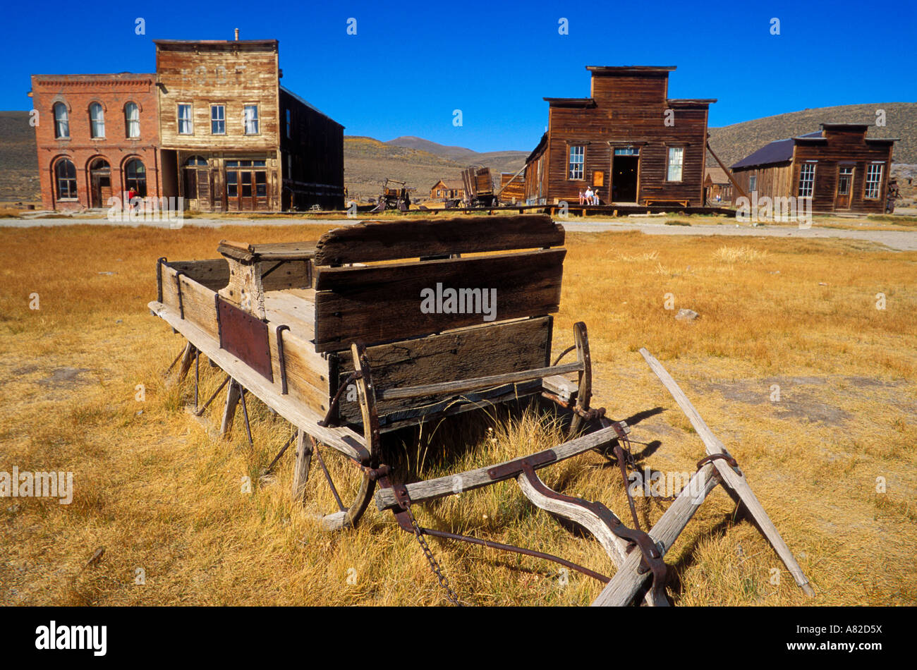 Wooden sleigh and store fronts on Main Street Bodie State Historic Park National Historic Landmark California Stock Photo