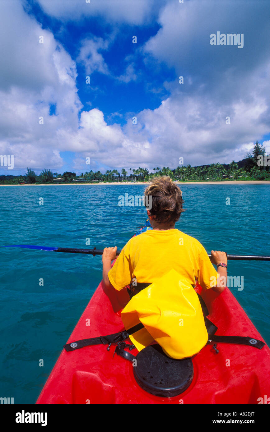 Boy kayaking on Hanalei Bay along the north shore Island of Kauai Hawaii Stock Photo