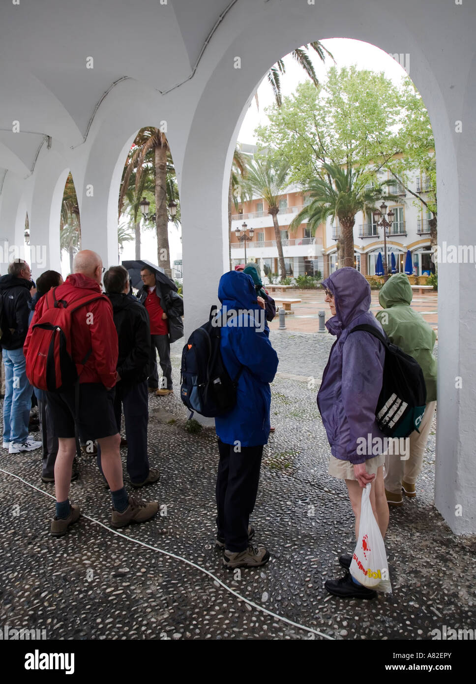 Dejected tourists on holiday sheltering from rain Nerja Spain Stock Photo