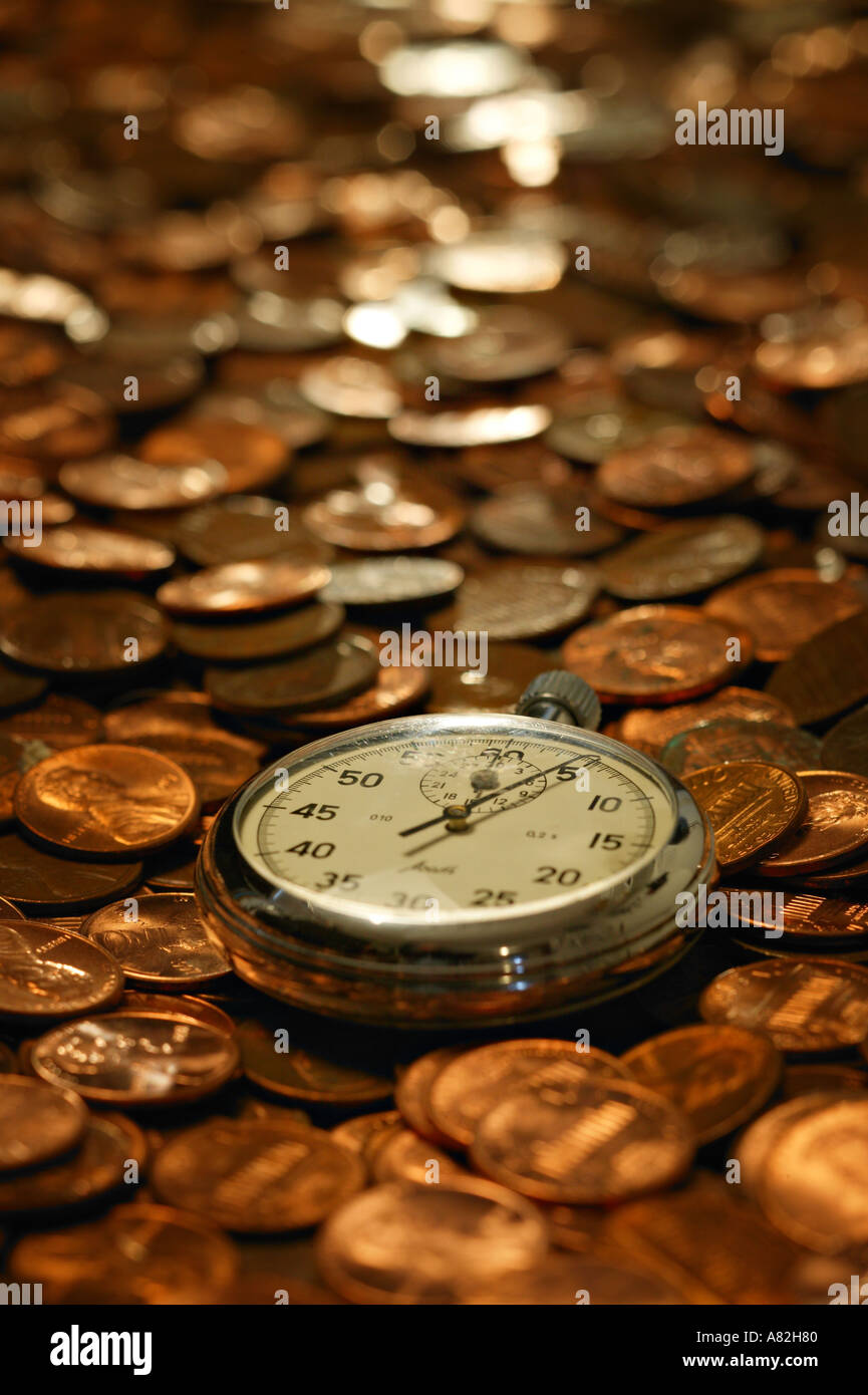 Stopwatch on top of many US coins Stock Photo