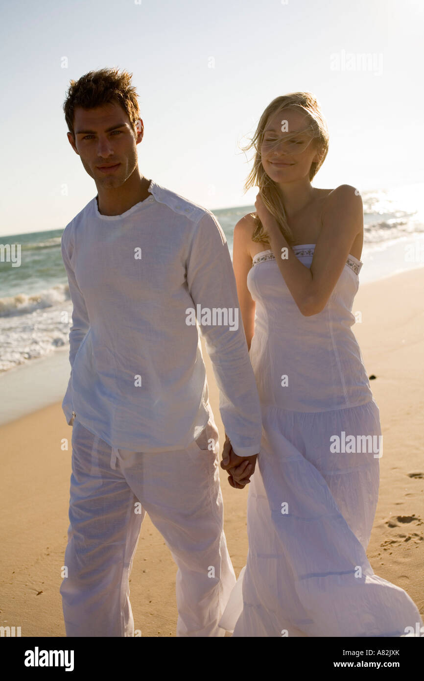 A couple at the beach holding hands Stock Photo - Alamy