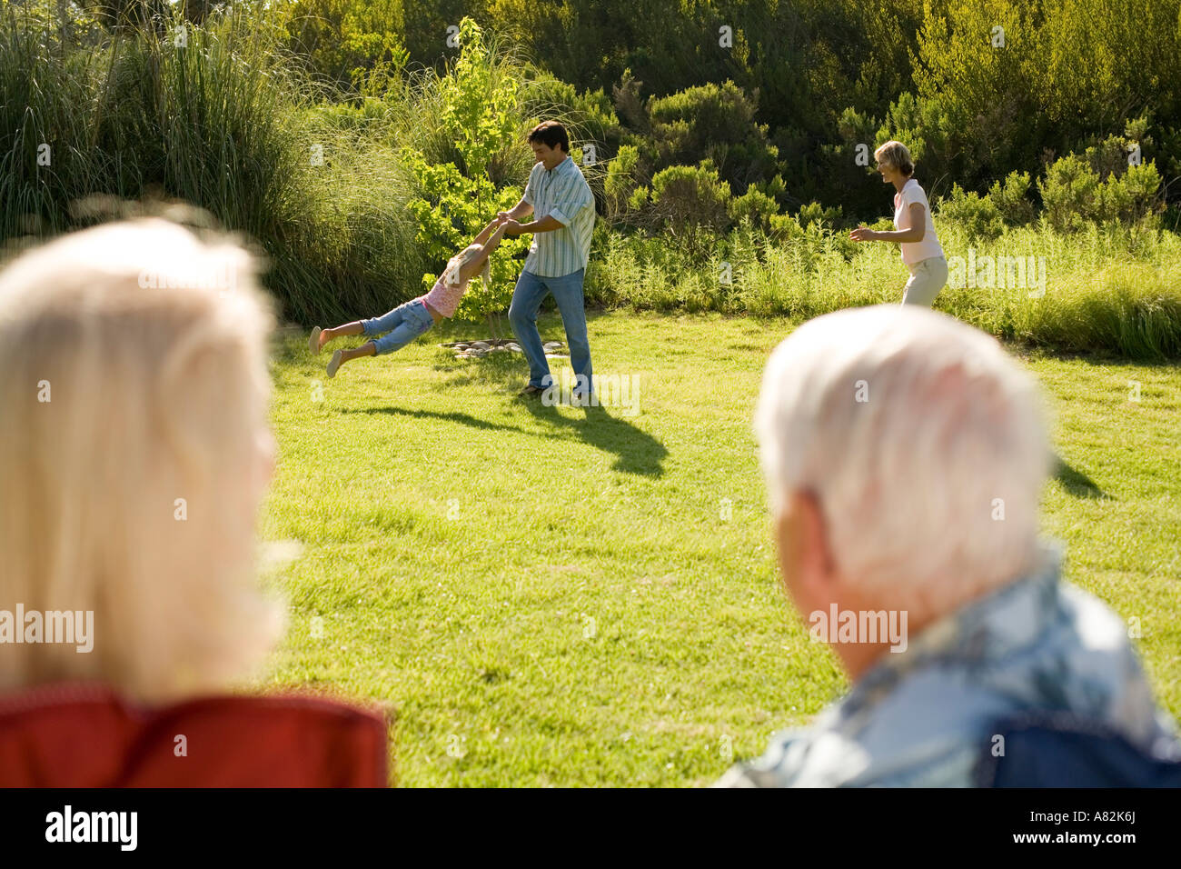 Mature woman swinging in park hi-res stock photography and images - Alamy