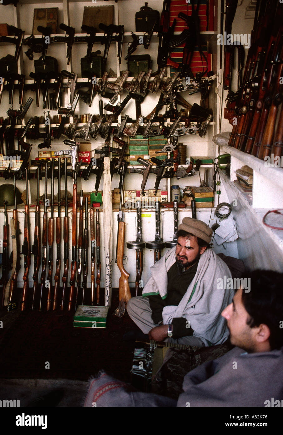 Pakistan NWFP Darra Adam Khel men in shop selling locally made guns