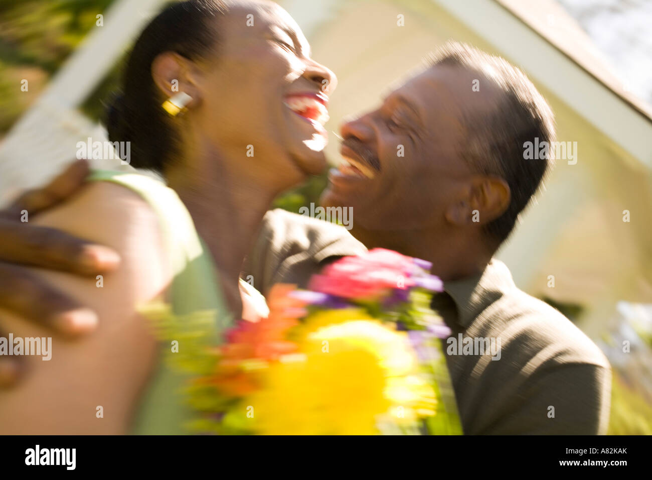 A couple with flowers outdoors Stock Photo - Alamy