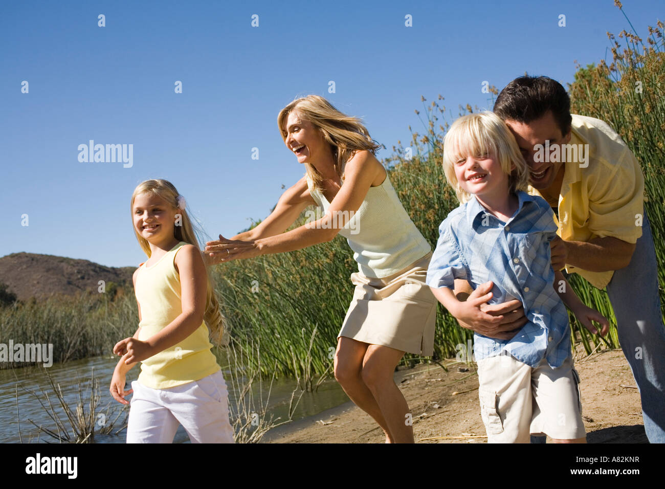 A family playing by a lake Stock Photo