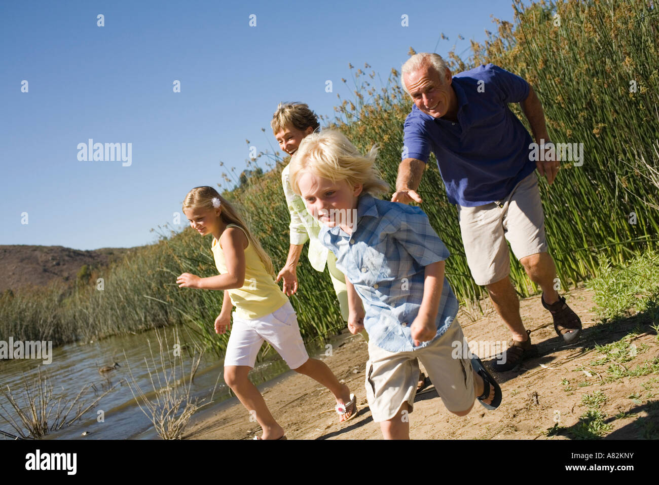 Grandparents and grandchildren by a lake Stock Photo