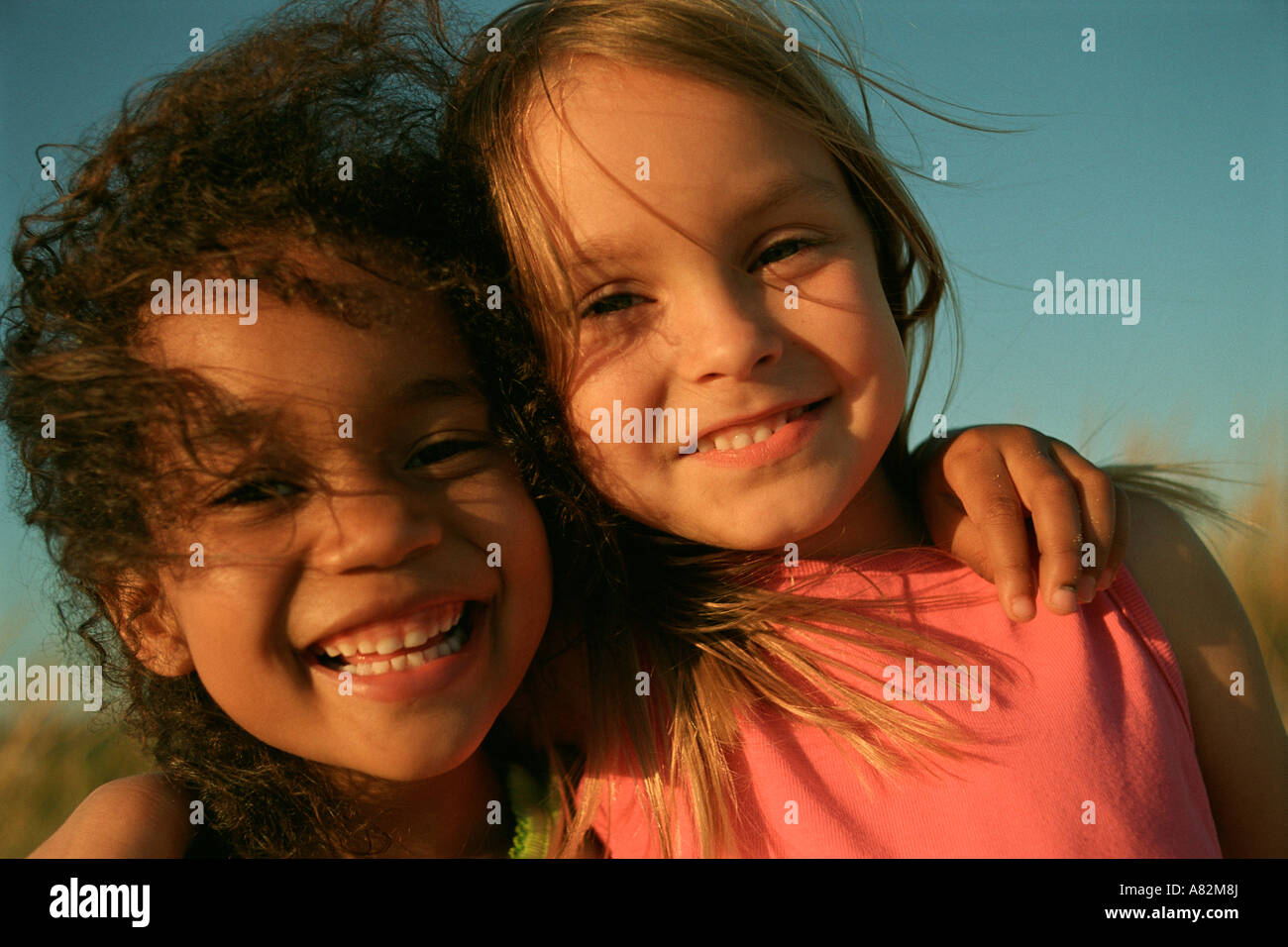Two girls outdoors in a field Stock Photo - Alamy