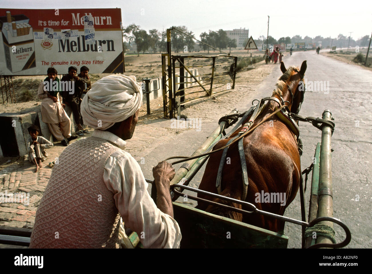 Pakistan South Punjab Bahawalpur horse cart driver passing Marlboro cigarette copy Melburn advertisement passengers view Stock Photo