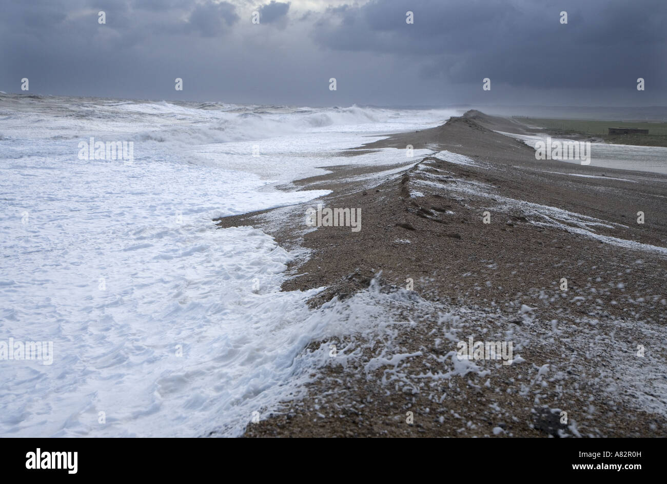 Spring Tide Breaching Sea Wall on Norfolk Coast at Cley Stock Photo