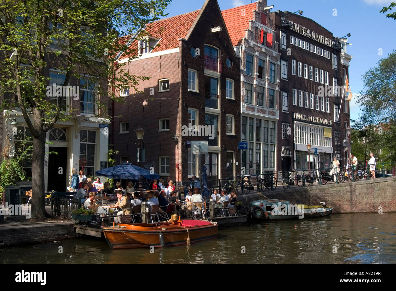 Amsterdam street cafe at a canal typical architecture Stock Photo
