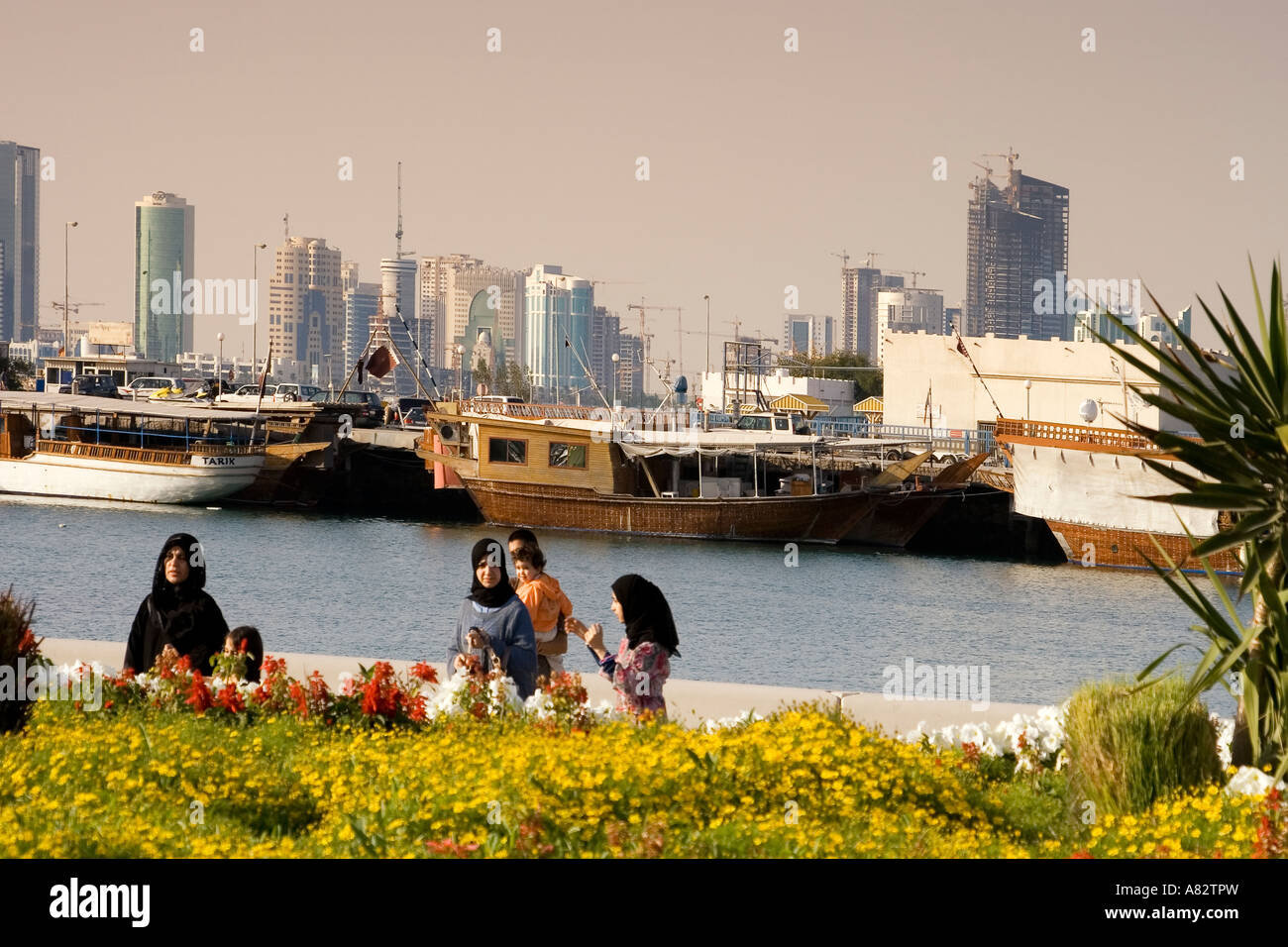 Qatar Doha bay skyline promenade veiled arabian women Stock Photo