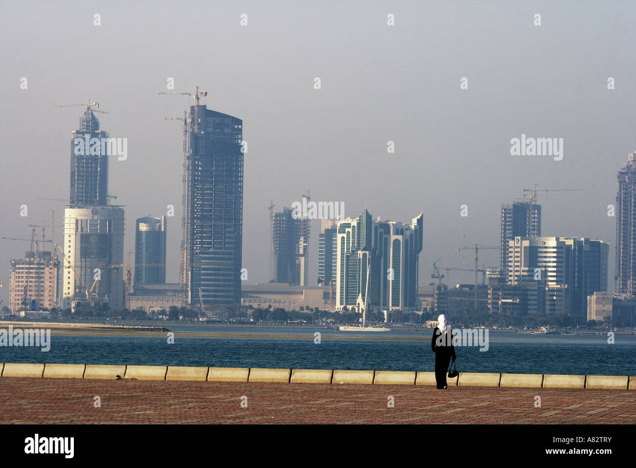 Qatar Doha bay skyline arabian woman Stock Photo