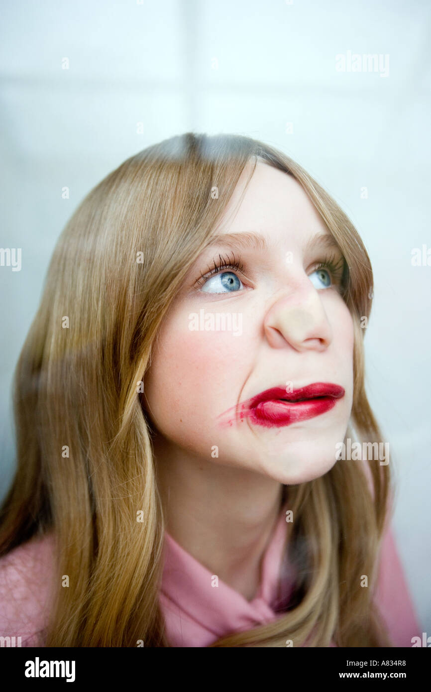Portrait of a young woman with her lips and nose pressed against a
