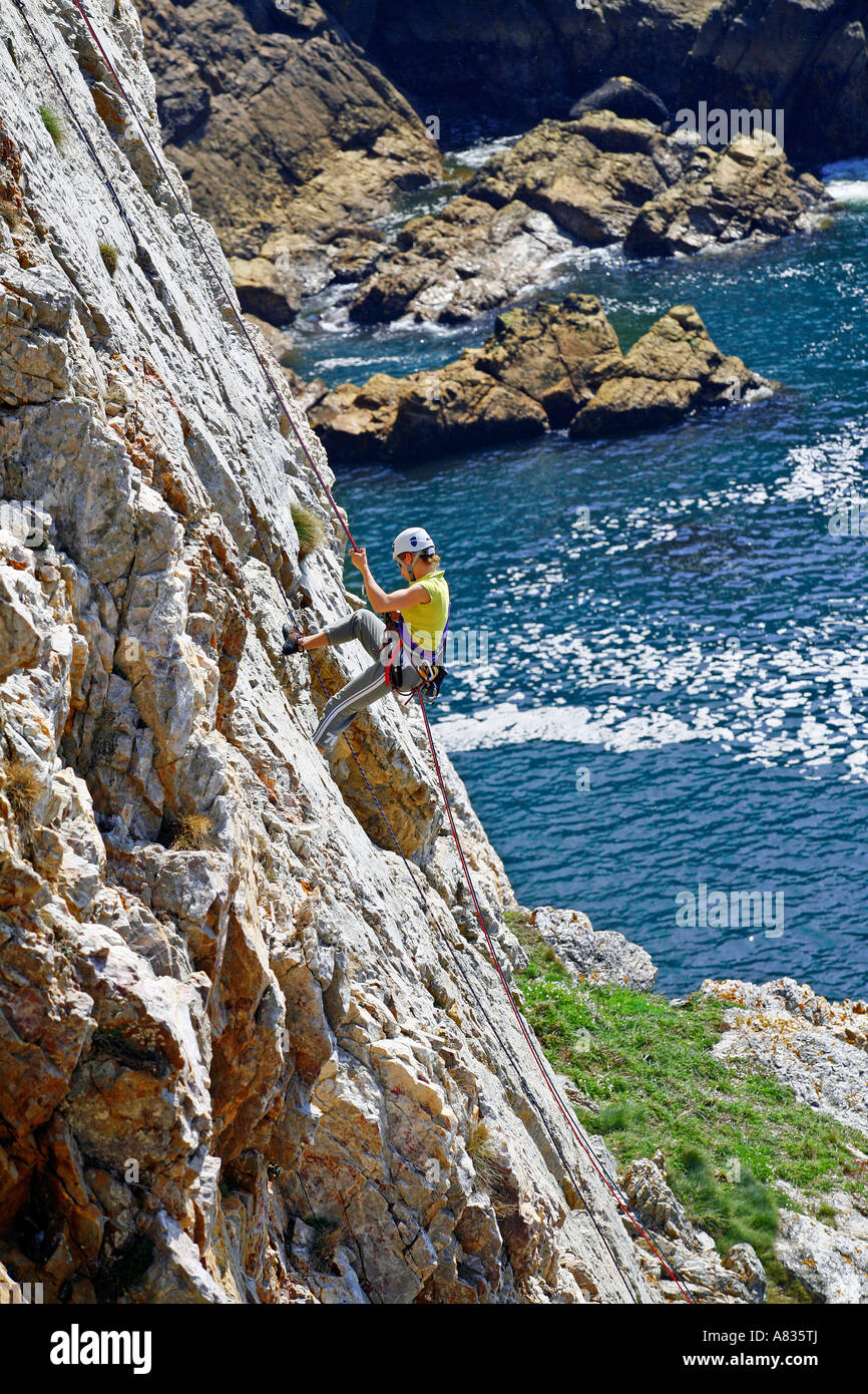 girl climbing in pointe de Penhir Brittany France Stock Photo