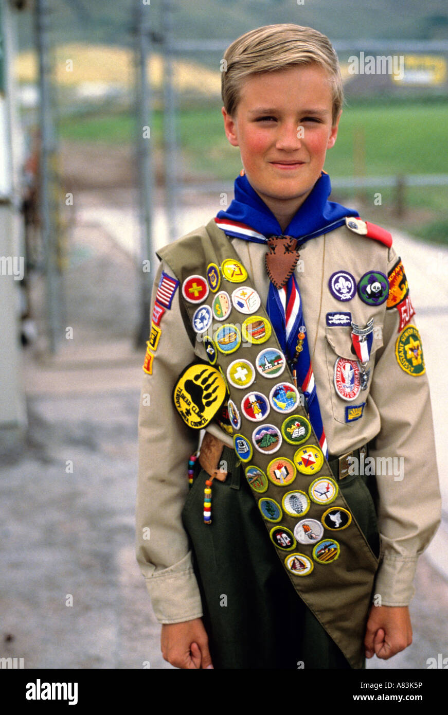 https://c8.alamy.com/comp/A83K5P/boy-scout-in-uniform-with-sash-of-badges-A83K5P.jpg