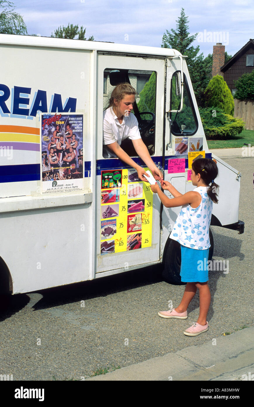 A child buying ice cream from an ice 